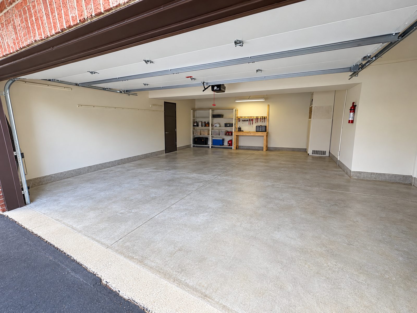 The same garage after cleaning, empty with a clean floor